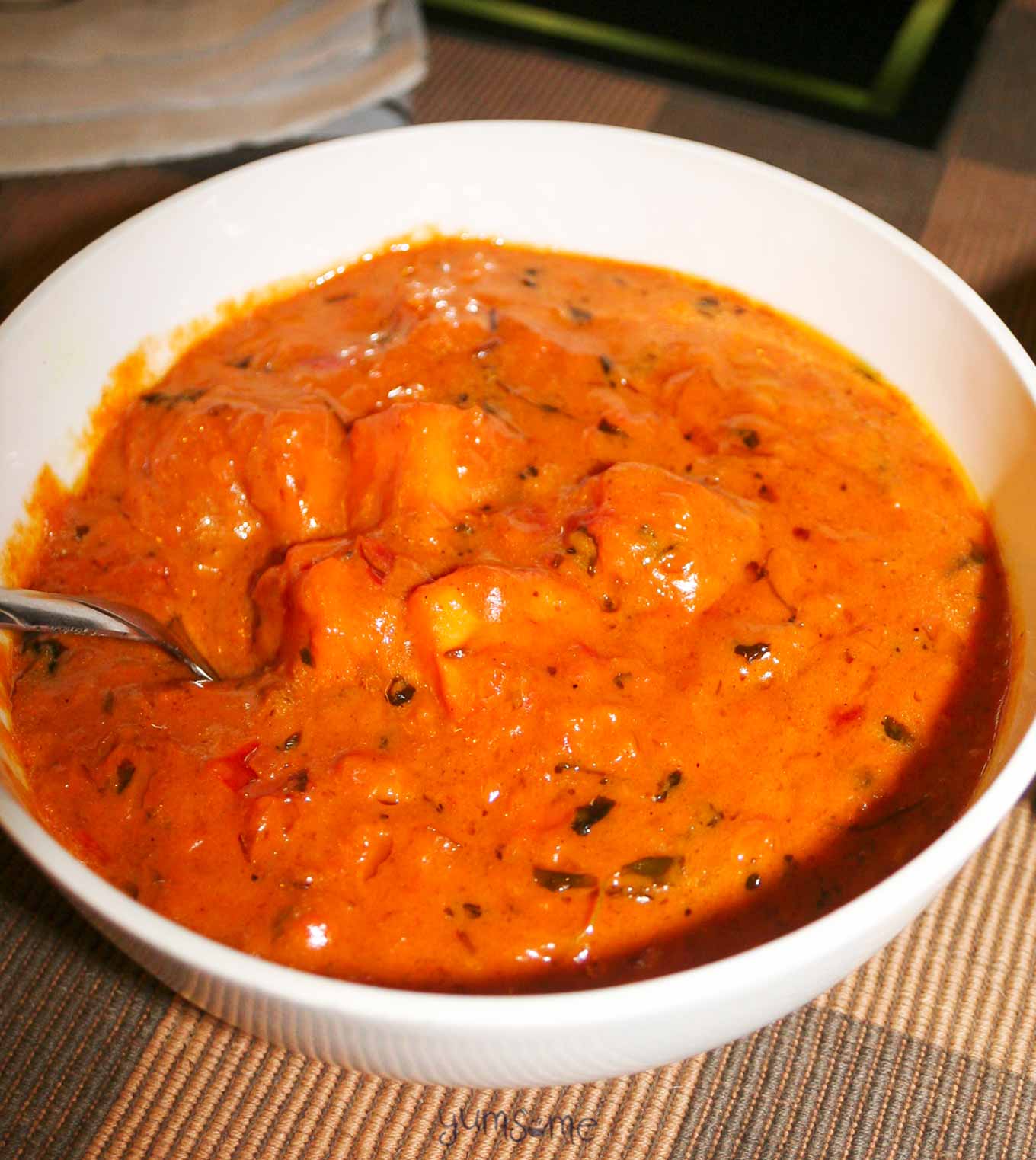 A bowl of tomato and vegetable masala.