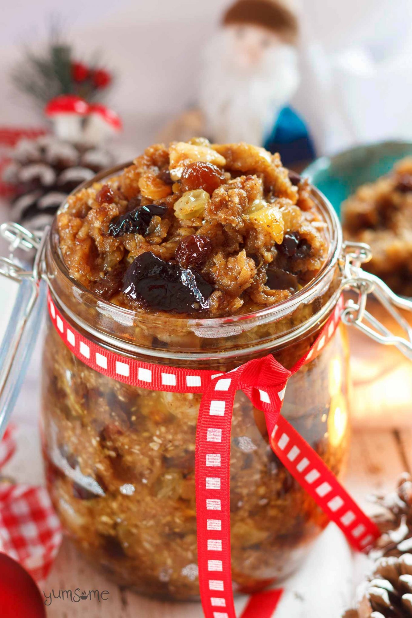 A jar of vegan mincemeat, with Christmas decorations in the background.