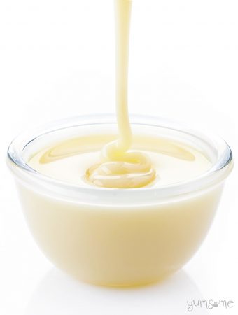 Vegan condensed milk being poured into a glass bowl.