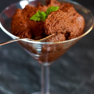 Vegan chocolate pudding with a spoon taking some out.