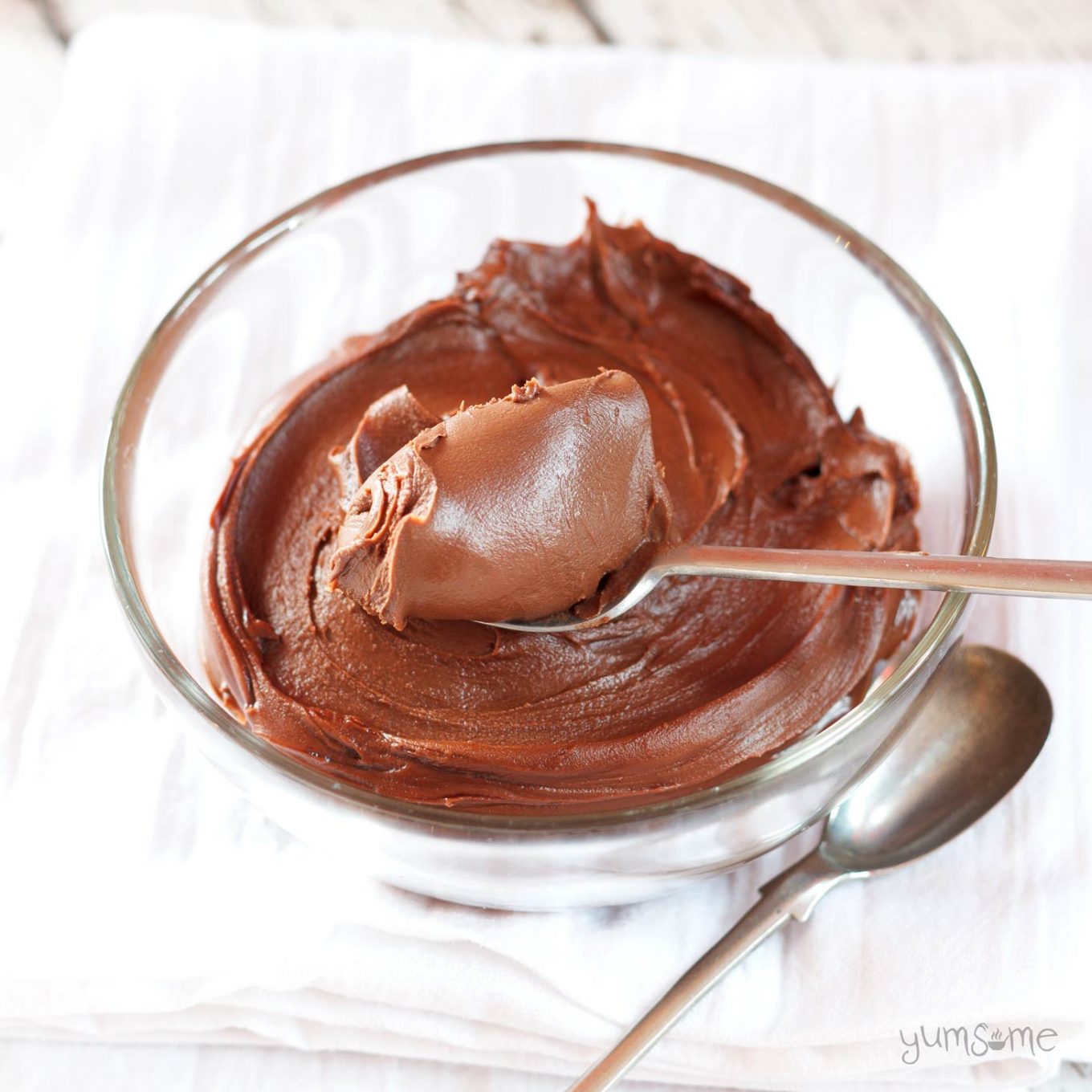 A glass bowl containing home-made vegan Nutella and a spoon.