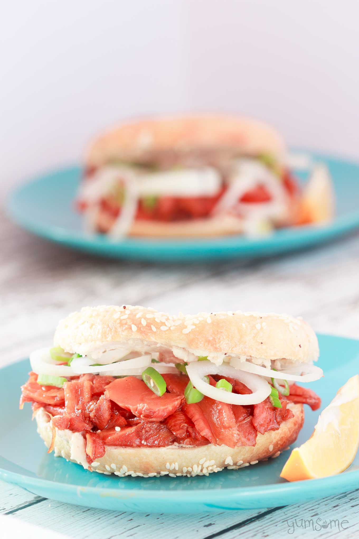 two bagels with carrot lox and cashew cream cheese.