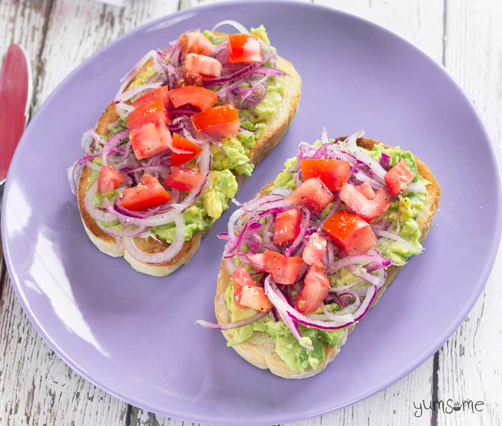 avocado and tomato bruschetta on a lilac plate | yumsome.com