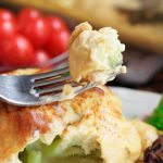 closeup of a forkful of veganized cauliflower cheese | yumsome.com