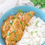 Overhead view of vegan butter chicken in a blue dish, with some rice.