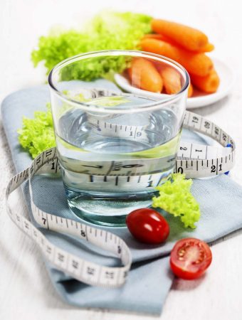 a glass of water, some fruit, and a tape measure | yumsome.com