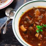 cropped image of a dish of hearty vegan mushroom soup | yumsome.com