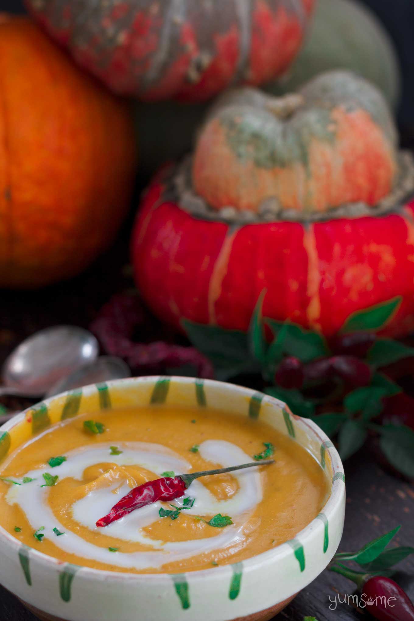 pumpkins and a bowl of Curried Coconut Butternut Squash Soup | yumsome.com