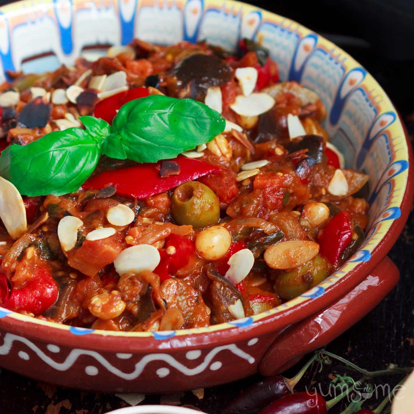 Closeup of sicilian caponata in a colourful dish.