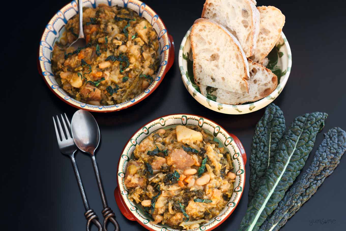 Overhead shot of two bowls of ribollita with a bowl of bread.