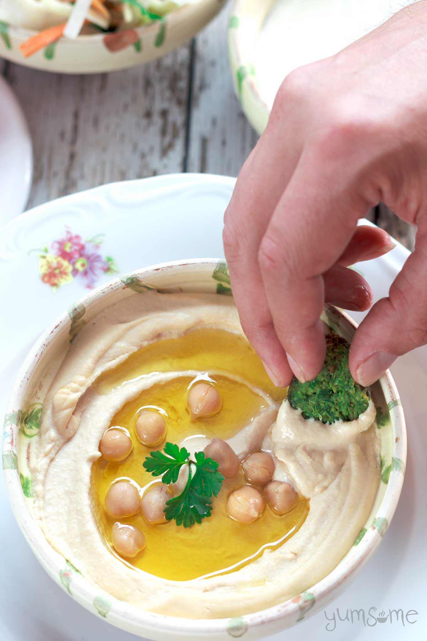 A bowl of perfectly smooth and creamy hummus.