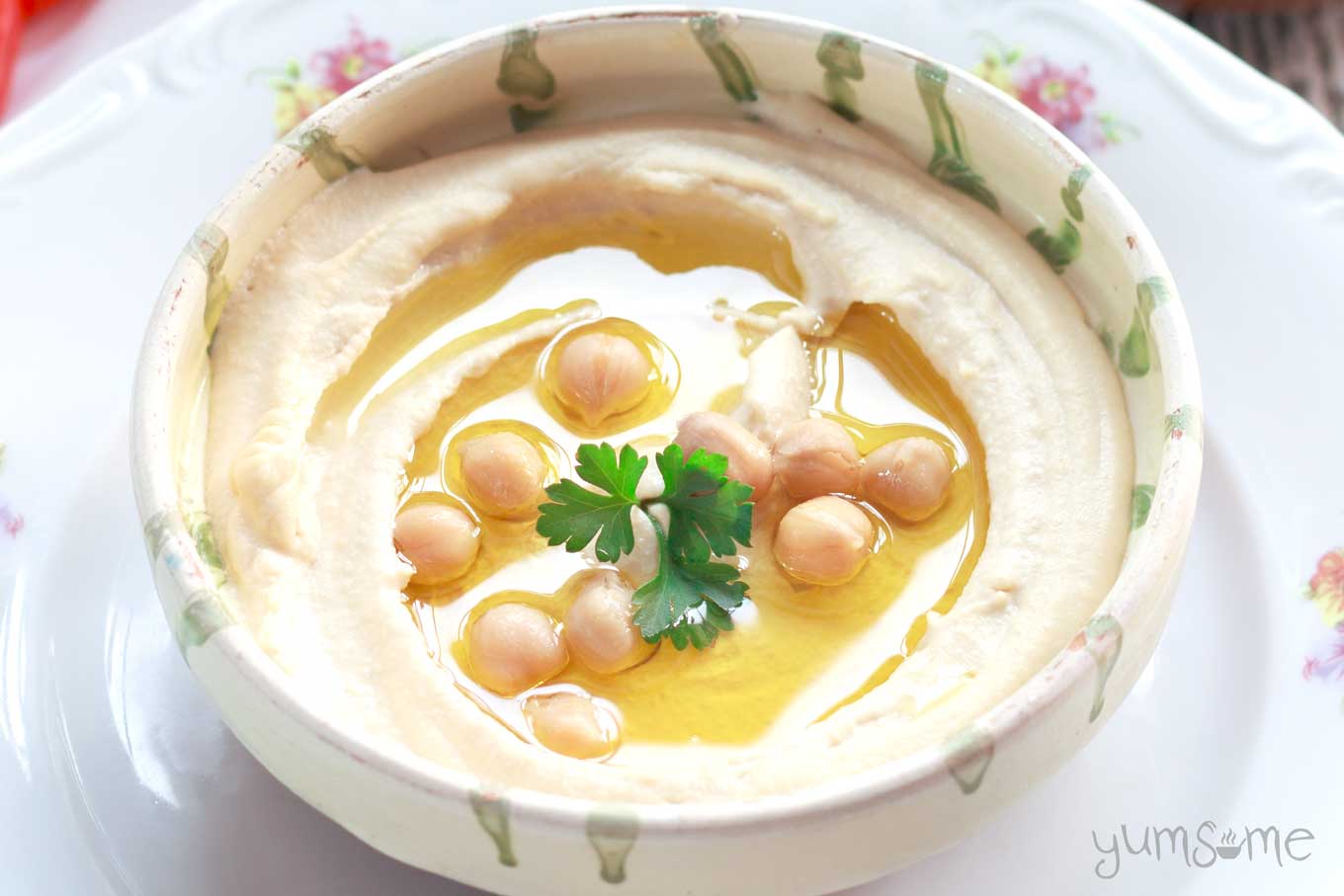 Smooth and creamy hummus in a decorated bowl.