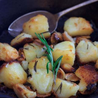 closeup shot of vegan mayo roast potatoes and some rosemary | yumsome.com