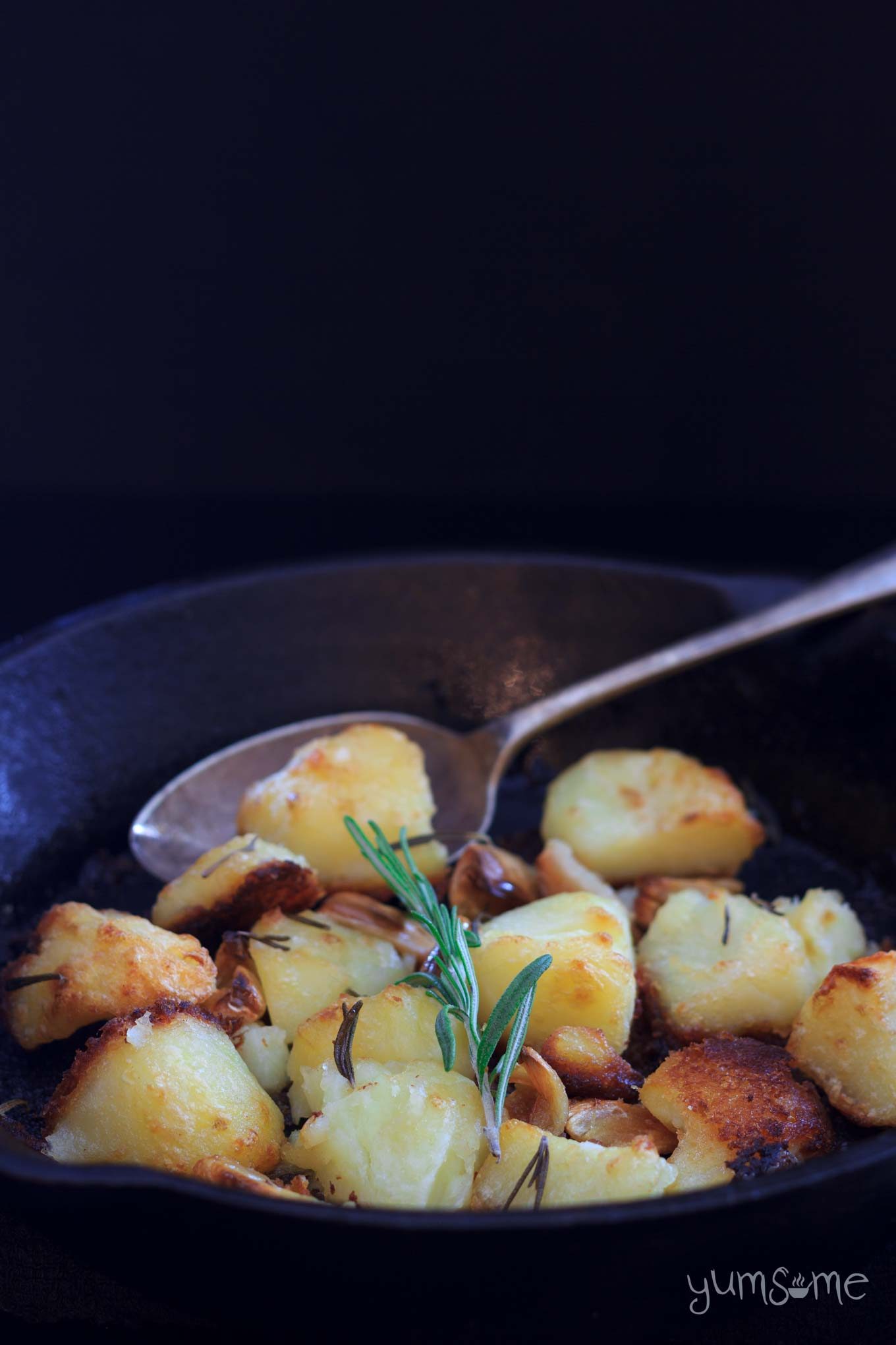 vegan roast potatoes and rosemary in a pan | yumsome.com