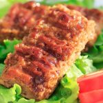 Vegan bbq ribs on a bed of lettuce..