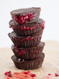 A stack of chocolate cups with red jam oozing out.