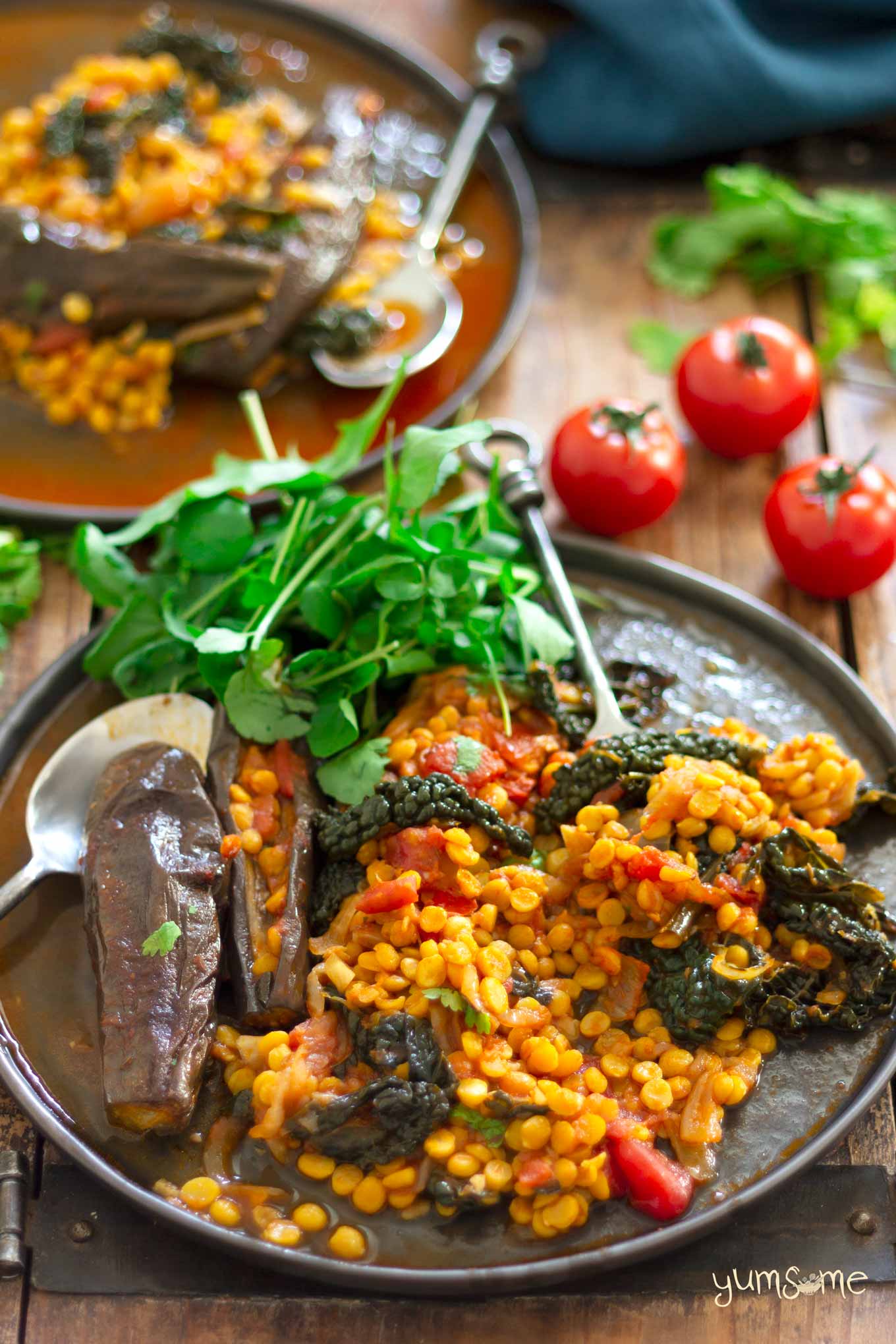 chana dal, eggplant, and kale casserole on a plate, with salad | yumsome.com