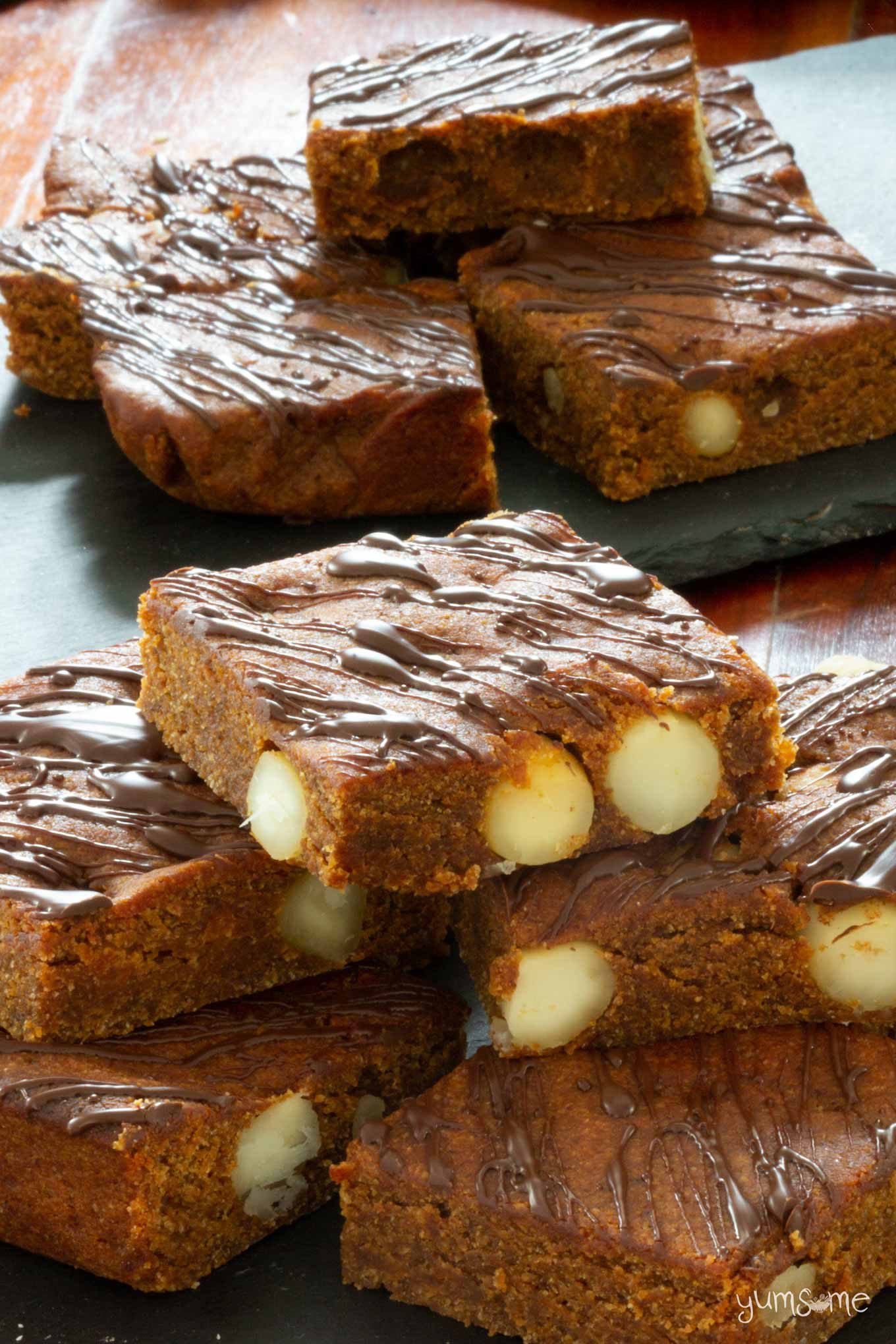 A stack of vegan cookie butter blondies with macadamias.