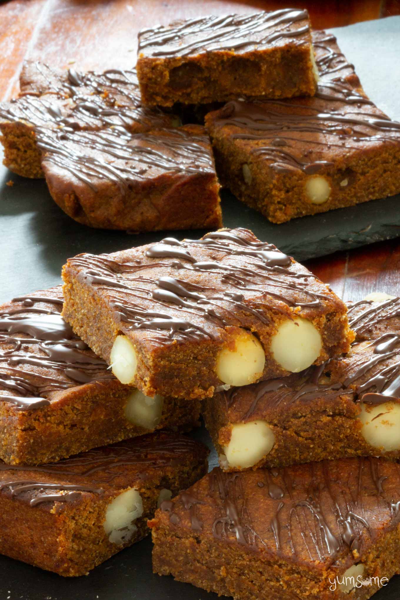 A stack of vegan cookie butter blondies with macadamias