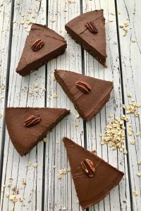 Five wedges of chocolate sweet potato pie on a grey table.