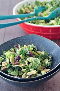 A grey dish full of brussels and kale chiffonade salad.