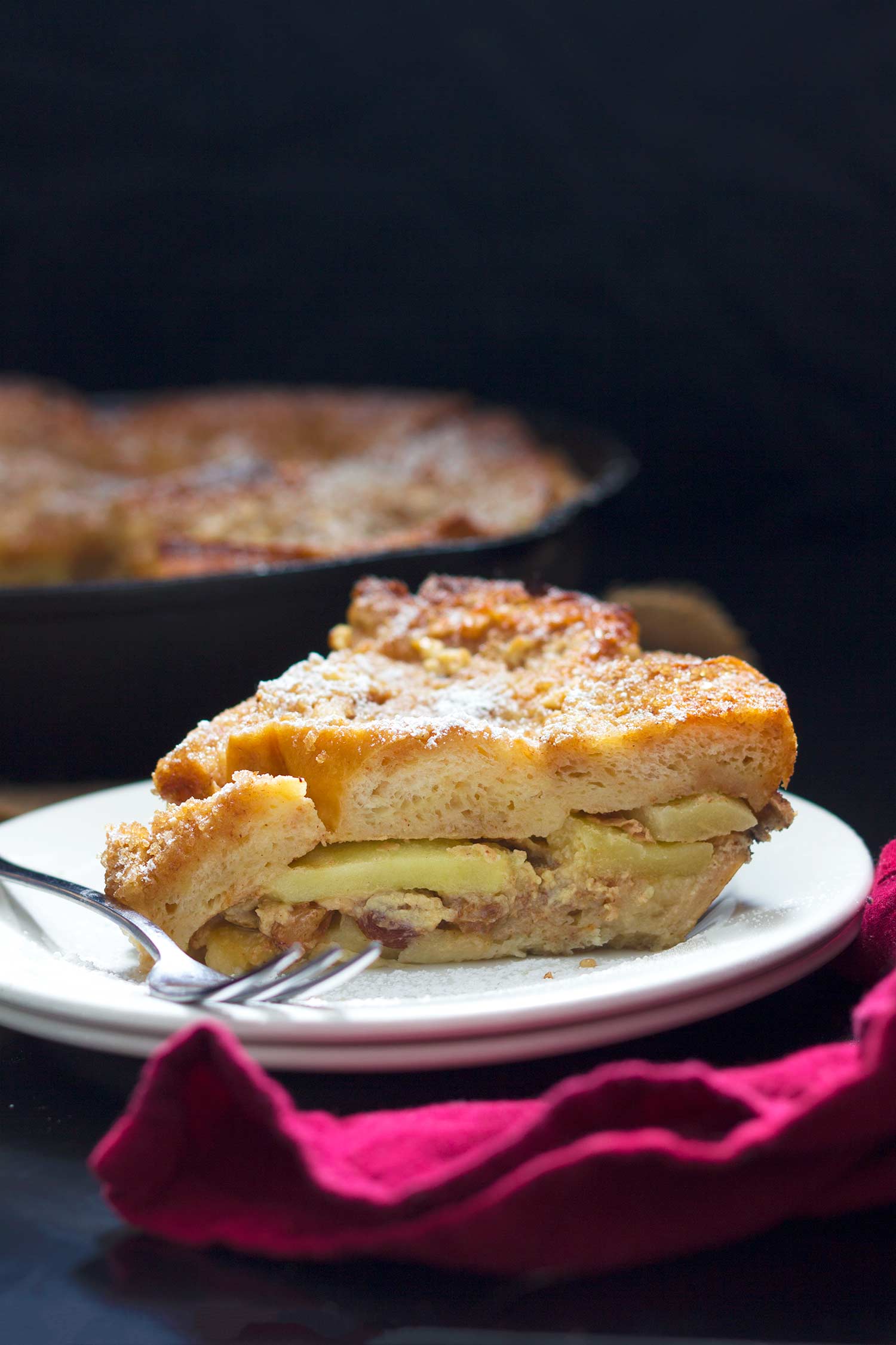 A slice of žemlovka on a white plate.